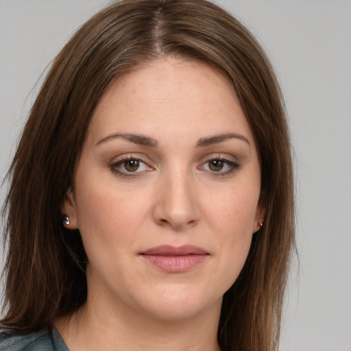 Joyful white young-adult female with long  brown hair and green eyes