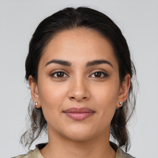 Joyful latino young-adult female with medium  brown hair and brown eyes