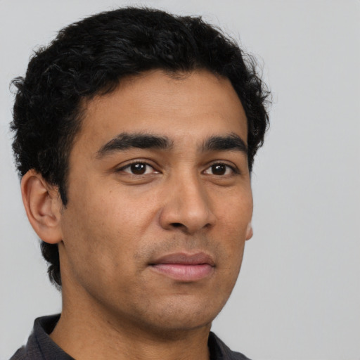Neutral latino young-adult male with short  black hair and brown eyes