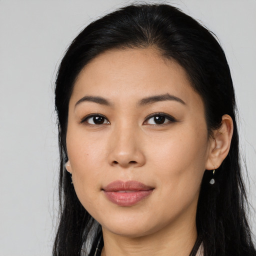 Joyful asian young-adult female with long  black hair and brown eyes