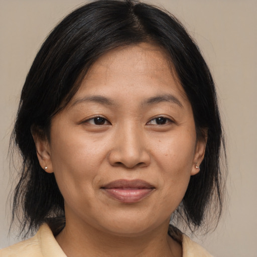 Joyful asian adult female with medium  brown hair and brown eyes