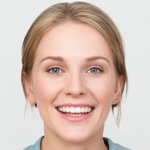 Joyful white young-adult female with medium  brown hair and blue eyes