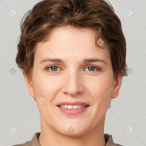 Joyful white young-adult female with short  brown hair and grey eyes