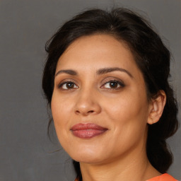 Joyful white adult female with long  brown hair and brown eyes