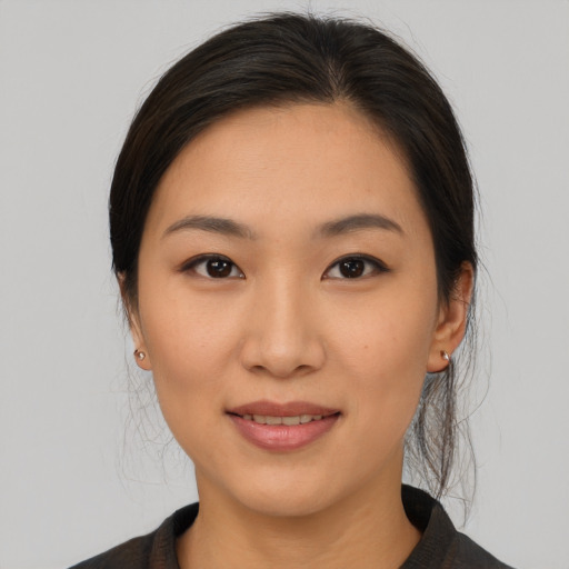 Joyful asian young-adult female with medium  brown hair and brown eyes