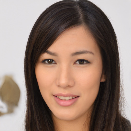 Joyful asian young-adult female with long  brown hair and brown eyes