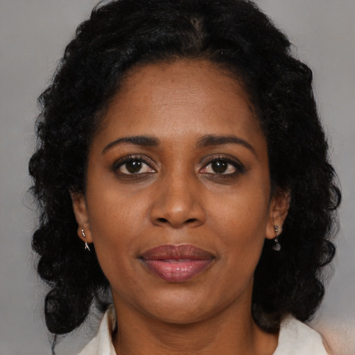Joyful black adult female with medium  black hair and brown eyes