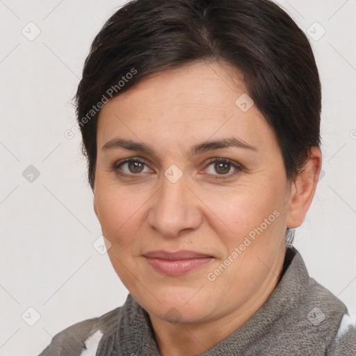 Joyful white adult female with short  brown hair and brown eyes