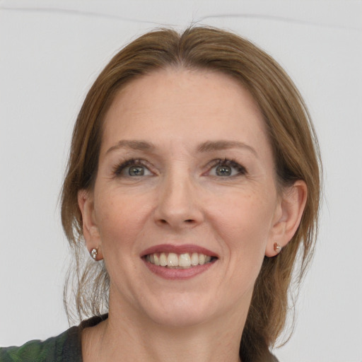 Joyful white young-adult female with medium  brown hair and blue eyes