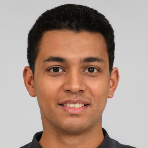Joyful latino young-adult male with short  black hair and brown eyes