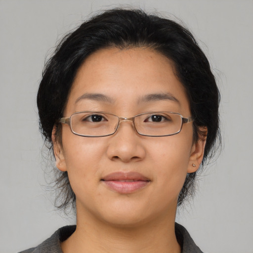 Joyful asian young-adult female with medium  brown hair and brown eyes
