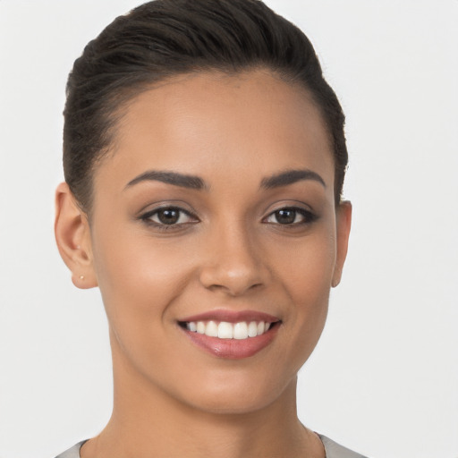 Joyful latino young-adult female with short  brown hair and brown eyes