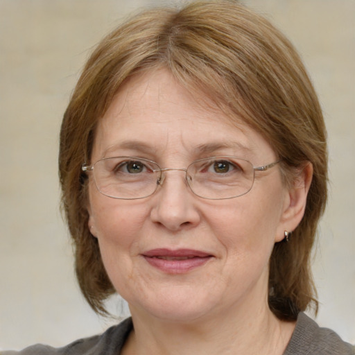 Joyful white middle-aged female with medium  brown hair and blue eyes