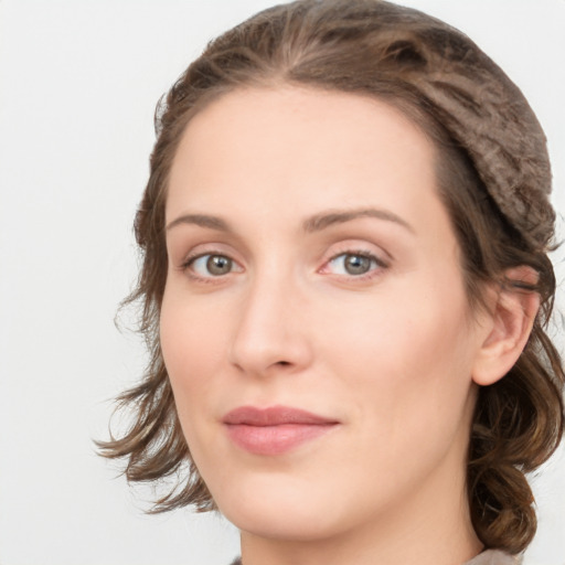 Joyful white young-adult female with medium  brown hair and green eyes