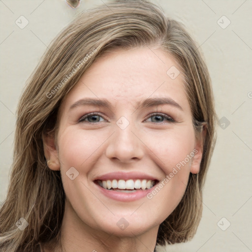 Joyful white young-adult female with long  brown hair and grey eyes