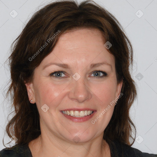 Joyful white adult female with medium  brown hair and blue eyes