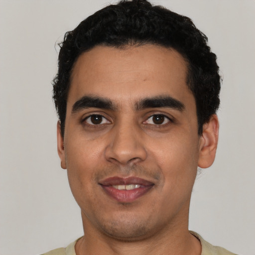 Joyful latino young-adult male with short  black hair and brown eyes