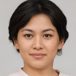 Joyful asian young-adult female with medium  black hair and brown eyes