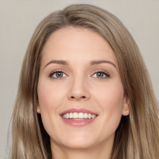 Joyful white young-adult female with long  brown hair and grey eyes