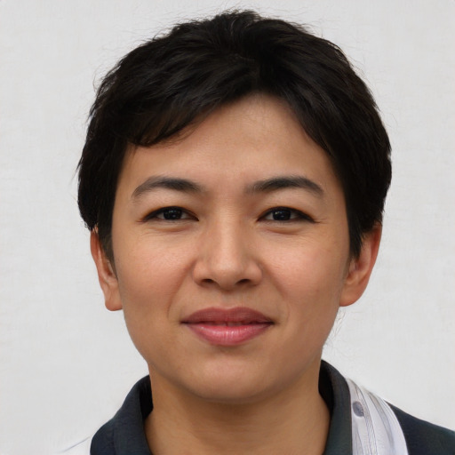 Joyful asian young-adult female with short  black hair and brown eyes