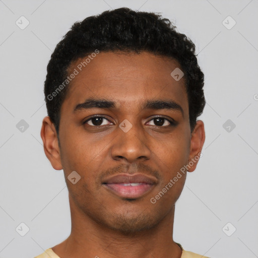 Joyful black young-adult male with short  black hair and brown eyes