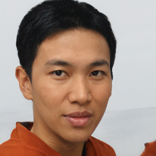 Joyful asian young-adult male with short  brown hair and brown eyes