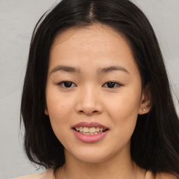 Joyful asian young-adult female with long  brown hair and brown eyes