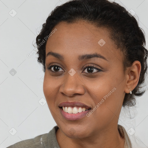 Joyful black young-adult female with short  brown hair and brown eyes