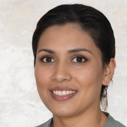 Joyful latino young-adult female with medium  brown hair and brown eyes