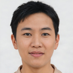 Joyful asian young-adult male with short  brown hair and brown eyes