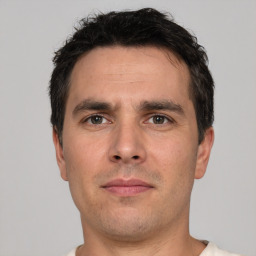 Neutral white adult male with short  black hair and brown eyes