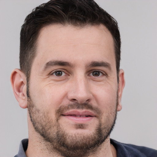 Joyful white adult male with short  brown hair and brown eyes