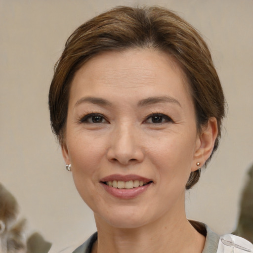 Joyful white adult female with medium  brown hair and brown eyes