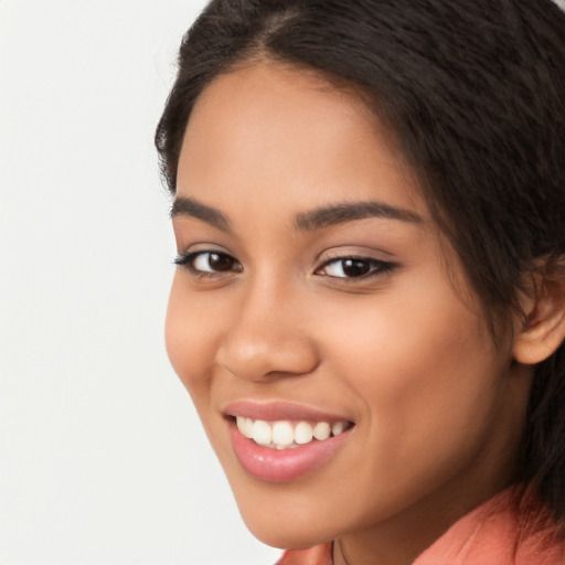 Joyful latino young-adult female with long  brown hair and brown eyes