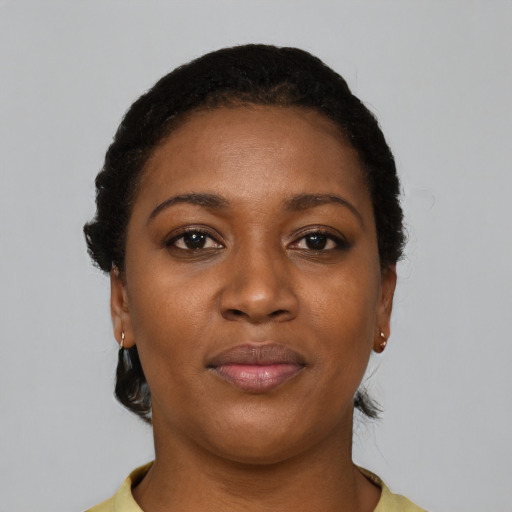 Joyful black young-adult female with short  brown hair and brown eyes