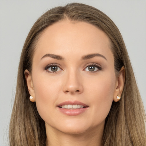 Joyful white young-adult female with long  brown hair and brown eyes