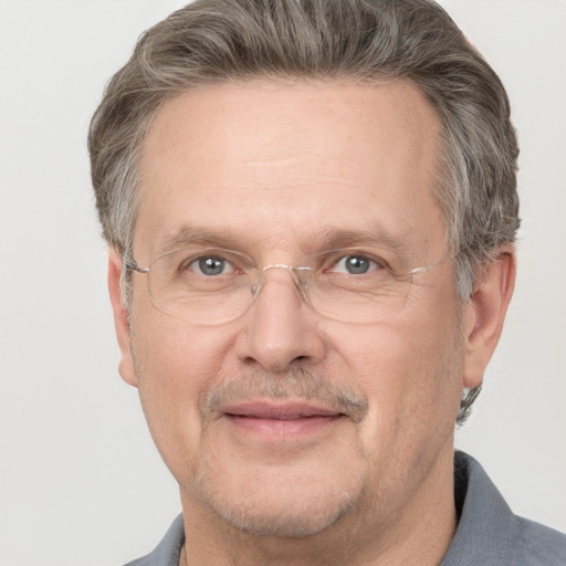 Joyful white middle-aged male with short  gray hair and grey eyes