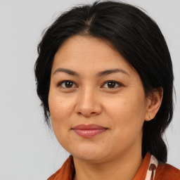 Joyful asian adult female with medium  brown hair and brown eyes