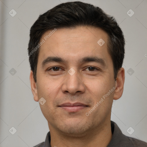 Joyful white adult male with short  black hair and brown eyes