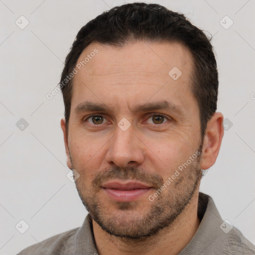 Joyful white adult male with short  brown hair and brown eyes