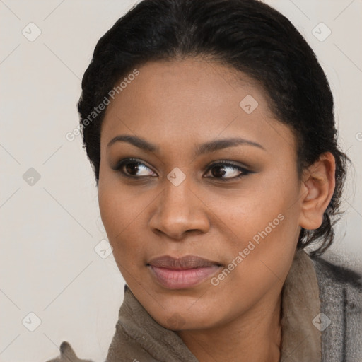 Joyful black young-adult female with short  black hair and brown eyes