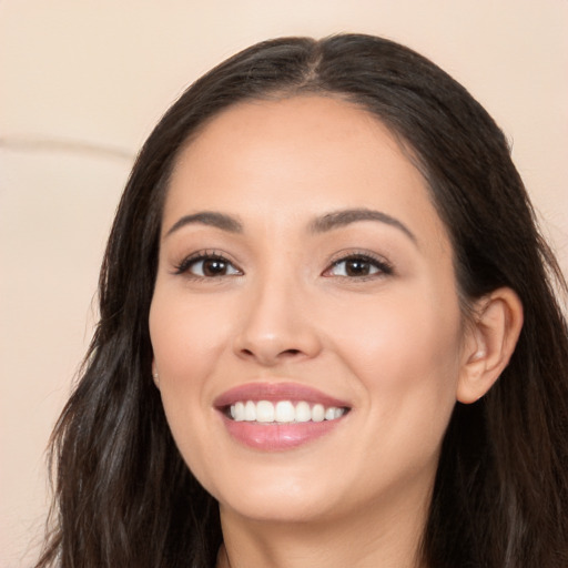 Joyful white young-adult female with long  brown hair and brown eyes