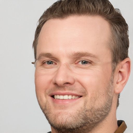 Joyful white adult male with short  brown hair and grey eyes