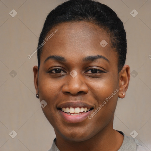 Joyful black young-adult female with short  black hair and brown eyes