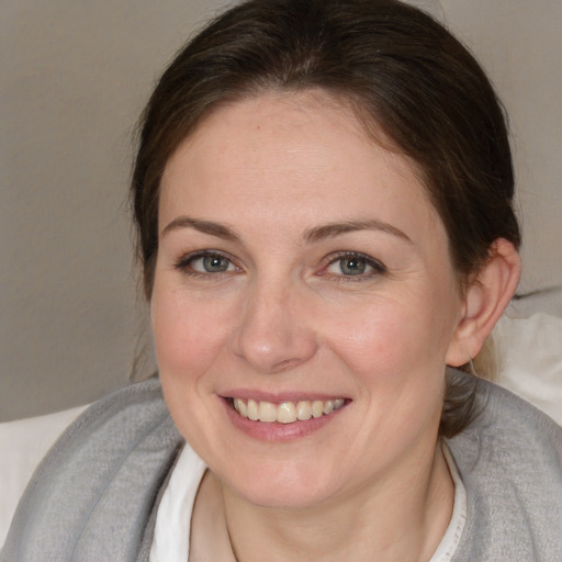 Joyful white adult female with short  brown hair and brown eyes