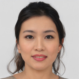 Joyful asian young-adult female with medium  brown hair and brown eyes