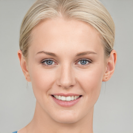 Joyful white young-adult female with medium  blond hair and blue eyes