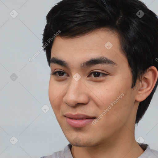 Joyful asian young-adult male with short  black hair and brown eyes