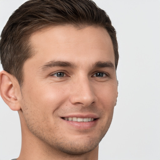 Joyful white young-adult male with short  brown hair and brown eyes