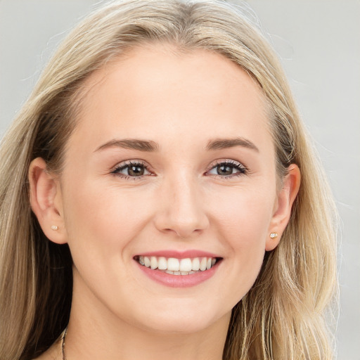 Joyful white young-adult female with long  brown hair and blue eyes